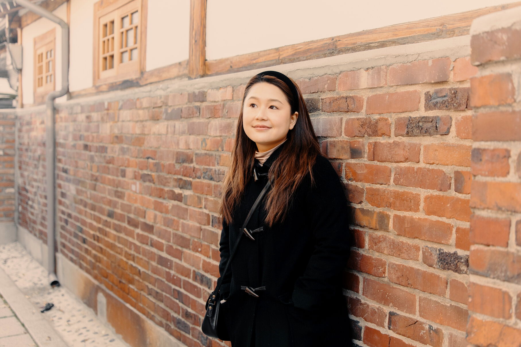 Woman Leaning on the Wall of Traditional Korean House